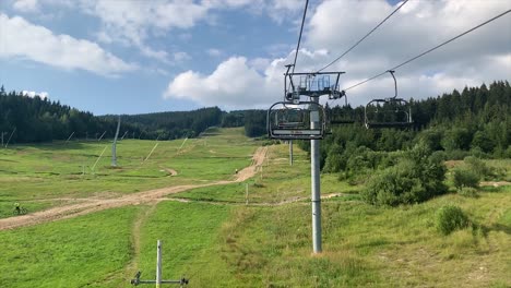 empty-Ski-lift-cable-way-in-summer-on-sunny-day-with-view-up-the-mountain