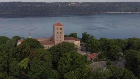 Clockwise-aerial-orbit-rising-above-The-Cloisters-museum-in-Upper-Manhattan-NYC-on-the-bank-of-the-Hudson-River
