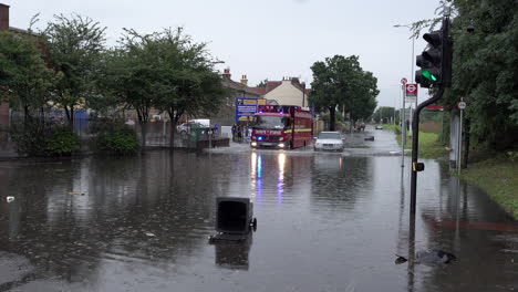 A-London-Fire-Brigade-engine-drives-past-and-abandoned-car-in-deep-flood-water-following-thunderstorms-that-saw-more-than-a-month’s-worth-of-torrential-rain-fall-in-several-hours-across-the-capital
