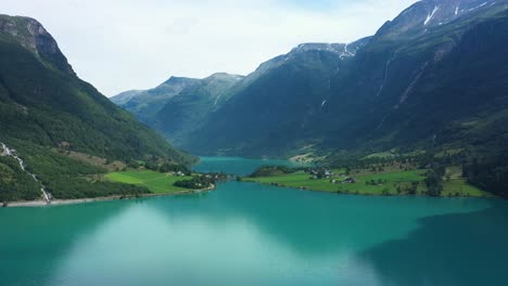 Spectacular-Oldedalen-valley-and-Oldevatnet-freshwater-lake---Turqoise-glacial-water-and-tall-mountains-with-lush-mountainside---Summer-day-panoramic-aerial