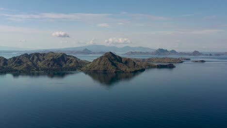 Volcanic-landscape-remnants-of-the-formation-of-Komodo-Island-Indonesia,-Aerial-pan-right-panorama-view