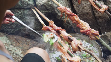 Cooking-meal-on-campfire-over-rocks-in-jungle