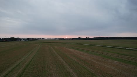 Drone-dolly-moving-forward-over-gravel-road-towards-sunset