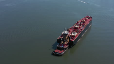 A-drone-view-of-a-large-red-barge-on-the-Hudson-River-in-NY