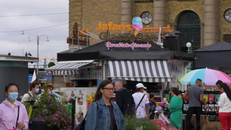 New-normal,-handheld-shot-capturing-people-passing-by-the-popular-Swedish-Jafari's-donuts-food-stall-in-central-square-Gothenburg-Sweden-during-daytime