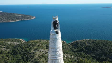 Scenic-View-Of-Our-Lady-Of-Loreto-Statue-In-Primosten,-Croatia-At-Daytime---aerial-drone-shot