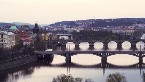 Prague-downtown-bridges-over-Vltava-river,-panning-left-evening-view-after-sunset