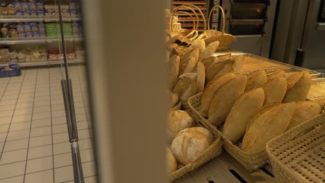 Pan-left-shot-of-breads-on-display-in-supermarket-bakery