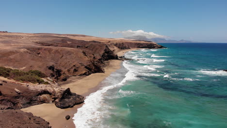 Aerial-shot-of-the-coast-of-La-Pared-beach-in-Fuerteventura-on-a-sunny-day