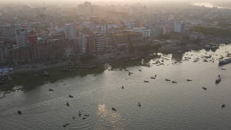 Aerial-backward-zoom-of-Ganges-river-banks-in-a-dusty-sunset