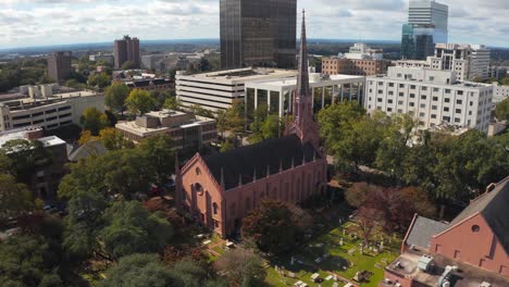 An-aerial-of-First-Presbyterian-Church-in-Columbia,-South-Carolina,-including-the-skyline-from-left-to-right