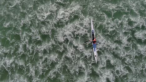 Birds-eye-view-of-a-person-kayaking-at-Lagoon-Beach-in-Cape-Town-South-Africa