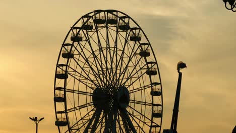 Ferris-Wheel-Silhouette-Against-Orange-Sunset-Sky