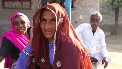 Indian-family-with-women-in-traditional-clothing-looking-at-camera,-Rajasthan