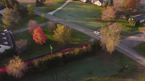 Beautiful-aerial-view-of-Michigan-country-road,-south-east-Michigan-with-greens-on-the-side-of-the-empty-road-with-houses-in-USA