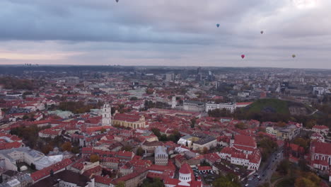 Hot-Air-Balloons-above-Vilnius-Old-Town-Aerial-Establishing-View,-Dusk
