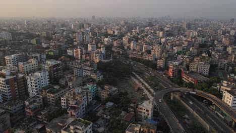 Large-train-traveling-through-Dhaka-metropolis,-Indian-city-in-Bangladesh