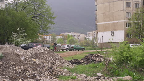 Neighborhood-of-old,-brutalist-apartment-buildings-and-a-pile-of-dirt-in-post-communist-Bulgaria-in-Eastern-Europe