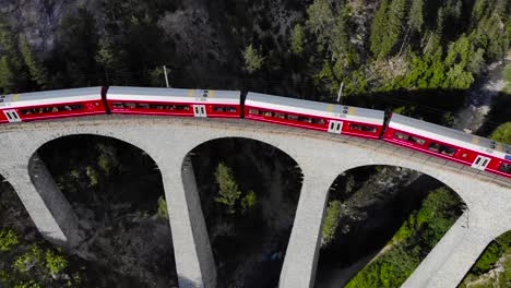 Aerial:-red-train-on-the-Landwasser-viaduct