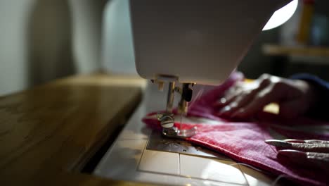 Using-a-sewing-machine-to-stitch-together-a-quilt-block---isolated-close-up