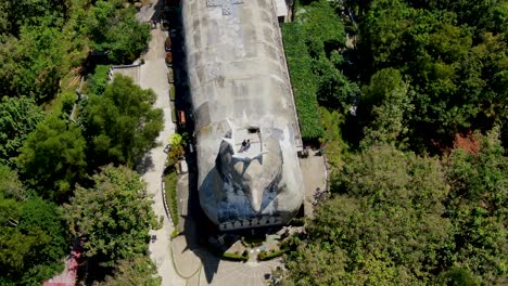 Church-building-formed-like-chicken,-aerial-top-down-view