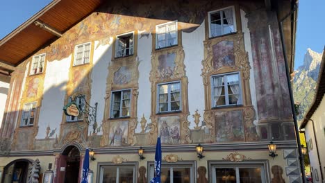 Historical-Alpenrose-Hotel-with-colorful-wall-paintings,-located-at-the-Obermarkt-street-of-the-old-bavarian-town-of-Mittenwald-in-Germany