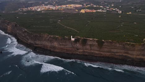 Cliffs-with-banana-plantation-fields-and-solidified-lava-in-sea-after-volcano-eruption-at-La-Palma