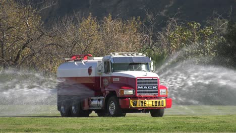 Water-Truck-spraying-a-field-down