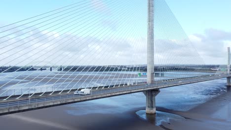 Mersey-gateway-landmark-aerial-view-above-toll-suspension-bridge-river-crossing-low-slow-push-in-shot