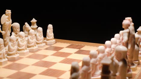 Dolly-motion-through-Chessboard-with-pieces-in-formation,-Slow-motion