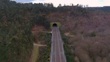 Aerial-Dolly-Back-From-Railway-Tunnel-Entrance-In-Rural-Landscape