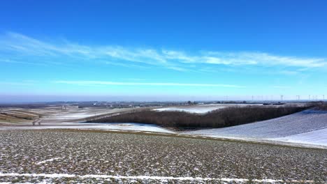 Drone-Flying-Over-Snowy-Farmland-Near-Zistersdorf-Town-In-Weinviertel,-Lower-Austria