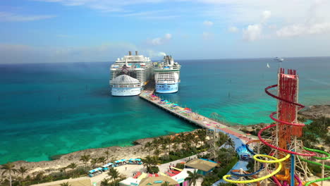 Wide-zooming-out-drone-shot-of-CoCoCay-island-with-Royal-Caribbean-cruise-ship-in-the-background