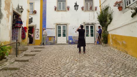 Young-Man-Taking-Photos-in-the-Main-Street-of-Castle-of-Óbidos