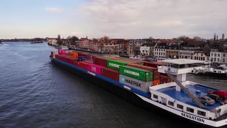 Aerial-Drone-View-Cargo-Container-Ship-Sensation-Sailing-Past-Dordrecht-Along-Oude-Maas