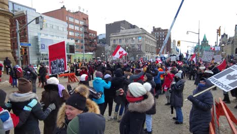 A-crowd-of-protestors-march-outside-Ottawa,-Ontario,-Canada