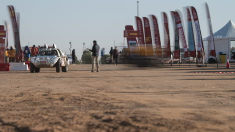 A-timelapse-view-of-the-camp-entrance-at-the-dakar-rally-as-competitors-arrive-from-a-long-tough-stage