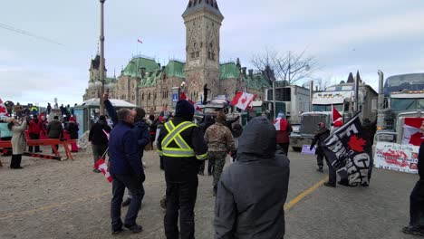Flag-Waving-Canadian-Protesters-For-The-Freedom-Convoy-Beside-East-Block-At-Parliament-Hill-In-Ottawa-On-January-28-2022