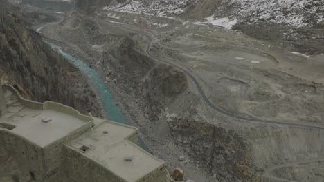 Aerial-Flying-Over-Altit-Fort-In-Hunza-Valley-From-Over-River-Dolly-Back