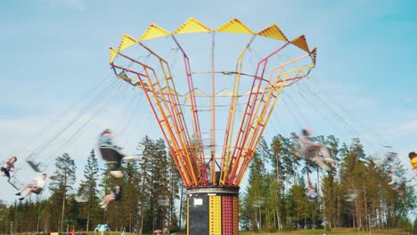 Ledmane-Parish,-Latvia---May-30,-2021:-Happy-People-Having-Fun-and-Enjoy-Chain-Swing-Carousel-Riding-Together-in-Amusement-Park