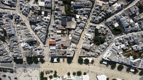 Aerial-drone-top-wide-shot-of-small-walking-streets-around-Alberobello,-Italy
