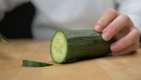 Cutting-cucumber-into-slices-with-a-sharp-knife