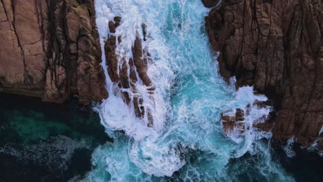 Topdown-of-aqua-waves-breaking-over-rocks-at-canal-rocks-Western-Australia