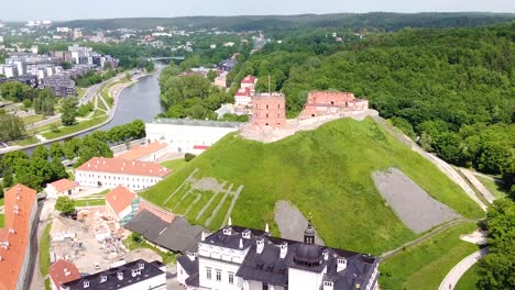 Vilnius-cityscape-surrounding-iconic-Gediminas-castle,-aerial-orbit-view