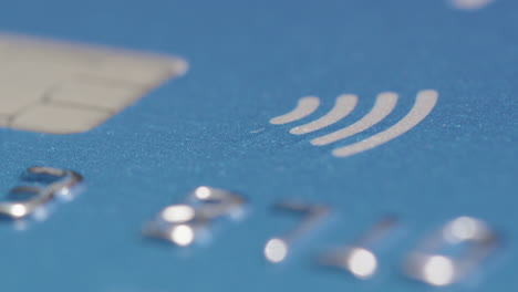 ZOOM-IN-shot-of-the-contactless-symbol-and-chip-on-a-credit-card
