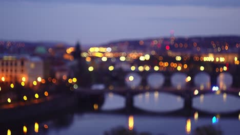 Police-or-ambulance-driving-across-Prague-bridge,-flickering-blurry-lights-effect,-low-aperture