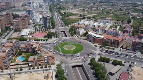 Aerial-Reveal-of-a-Traffic-Circle-in-a-Coastal-Port-City
