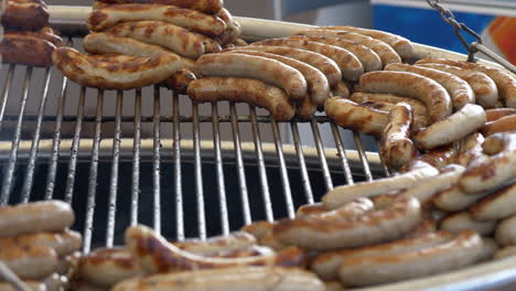 Close-up-shot-of-grilling-german-bratwurst-sausage-on-market-during-daytime---prores-422