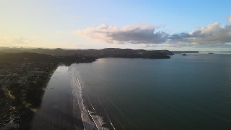 Sunset-seen-from-the-sky-by-drone-in-Orewa-Beach,-New-Zealand