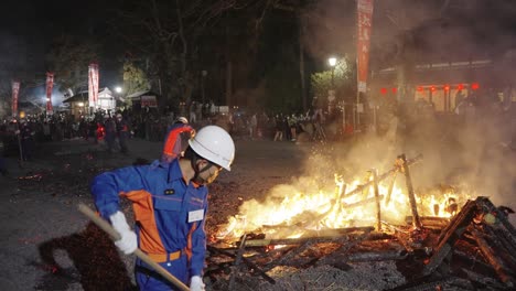 Omihachiman-City-Employees-Cleaning-up-Bonfire-at-Sagicho-Fire-Festival,-Japan